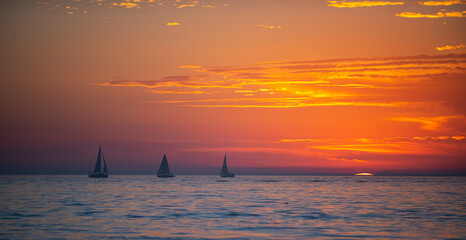 Sailboat at sea. Sea beach with sunset sky abstract background. Copy space of summer vacation and travel concept.