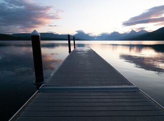 Obraz premium Dock Jutting into Lake McDonald in Glacier National Park, Montana, at Dawn