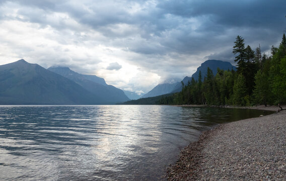 Pebbled Beach of Lake McDonald in Glacier National Park, Montana with Mountains in Background