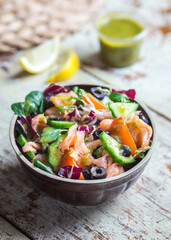 Smoked salmon salad with vegetables and vinaigrette dressing