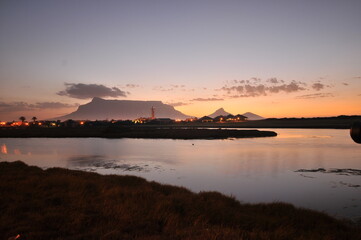 Table Mountain Panoramic Landscape with Beautiful Colorful Sunset and Streaking Clouds Landscape, Cape Town, South Africa. Sunset over the river. 