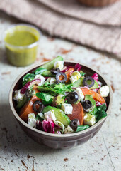 Greek salad with feta cheese vegetables and vinaigrette dressing