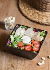 Cesar chicken salad with vegetables and garlic dressing