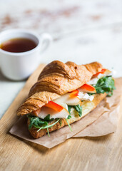 Freshly baked croissant with cheese and vegetables