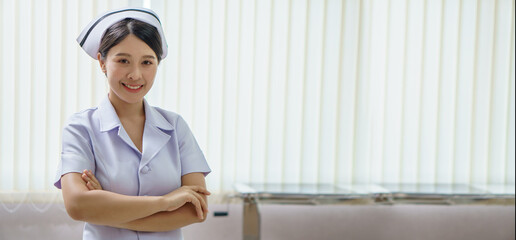 confident young asian thai nurse on indoor hospital background with copy space . banner and...