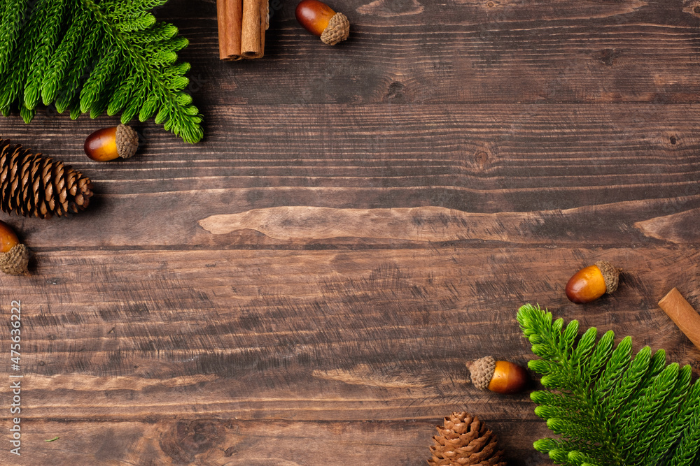 Poster christmas pine tree and pine cone on woooden table background