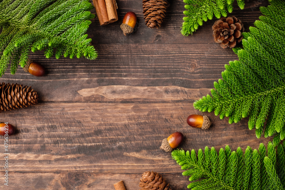 Poster christmas pine tree and pine cone on woooden table background