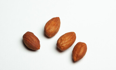 four hazelnuts on a white background