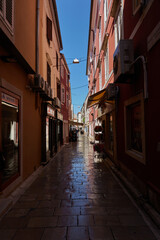 Fototapeta na wymiar Zadar, Croatia - August 7, 2021 - narrow streets of the ancient fishing town in the summer sunny afternoon
