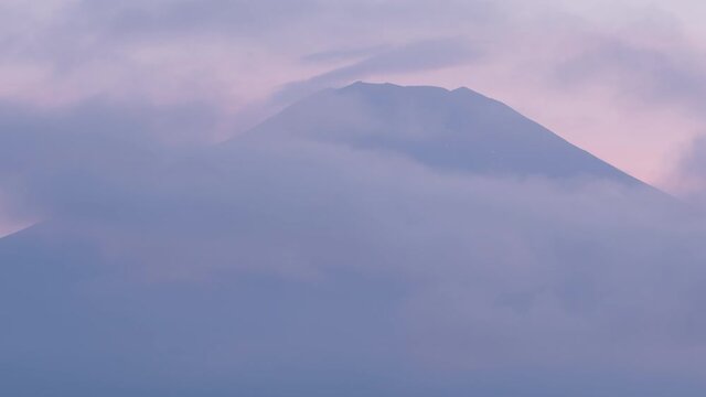 雲の中から現れる黄昏時の富士山のタイムラプス映像（パンニング）