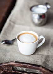 small cup of espresso macchiato coffee on table