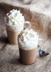 chocolate coffee with whipped cream on jute background