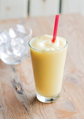 Iced lemon slushy smoothie in a tall glass - obrazy, fototapety, plakaty
