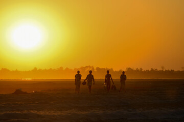 people on the way to home at sunset