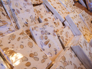 Bergamo, Italy. View of the Christmas market in the city center. Stalls selling different types of nougat