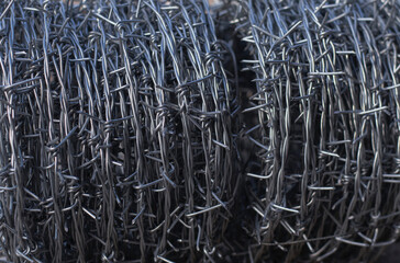 Barbed wire in rolls for use