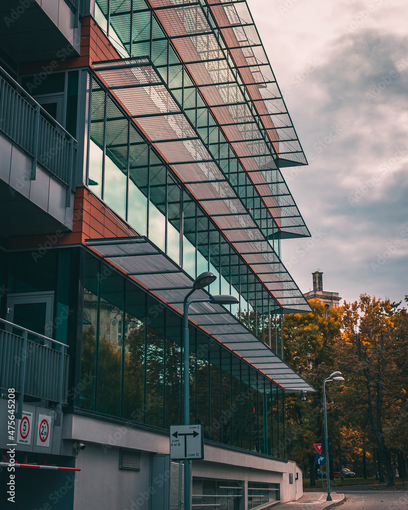 Poster beautiful view of a modern building with reflective windows on a cloudy day