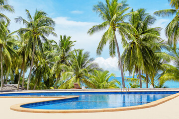 Obraz na płótnie Canvas Swimming pool blue water, sea beach poolside, tropical island nature, green palm trees, ocean coast landscape, sunny sky, clouds, summer holidays, vacation, travel, relax leisure, luxury resort, hotel