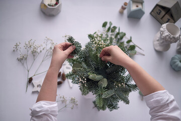 Workshop Master class handmade a Christmas table decoration. Hands close-up. Christmas decor made...