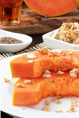 Healthy food concept, ripe papaya with granola and chia seed.