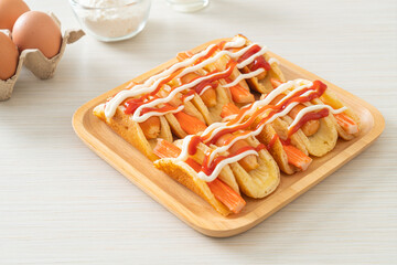 flat pancake roll with sausage and crab stick