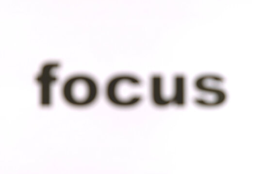 The word 'focus' intentionally blurred, unwittingly drawing viewers to focus on it. Blurry 'focus' text, concept for life or doing task without purpose, goalless, or being unmotivated, uninterested.