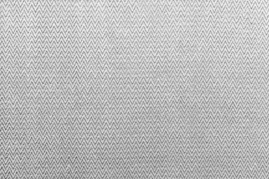 Grey matting fabric with a triangular pattern of cotton as a background. The texture of natural fabric.