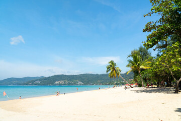 People relax on beach holiday vacation. Family trip swimming in sea water happy and fun. Coconut trees seaside mountain background.
