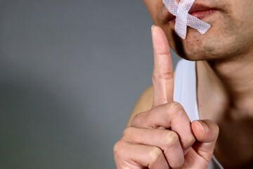 口止めをする人物のイメージ写真