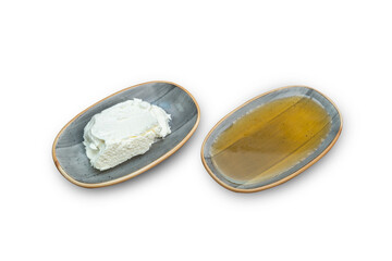 honey and cream in porcelain plate on isolated white background
