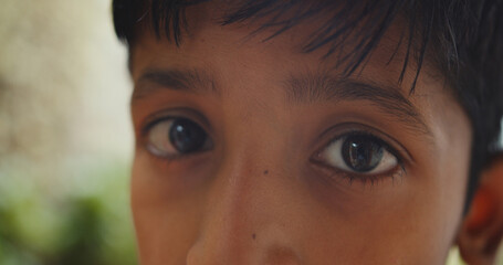 Closeup of the a young South Asian boy's almond eyes