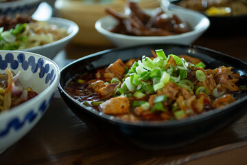 A view of several modern Chinese entrees, featuring a dish of minced pork.