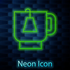 Glowing neon line Cup of tea with tea bag icon isolated on brick wall background. Vector
