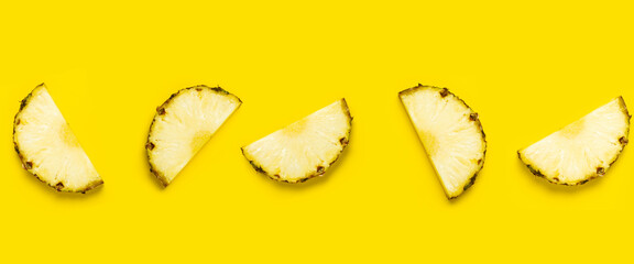 Pineapple slice against on a yellow background. Top view, flat lay. Banner