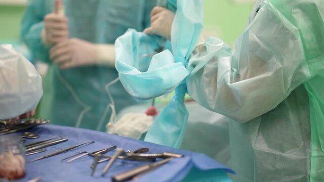 inside modern surgery, table with tools of surgeon, health professionals is working