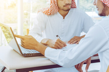 Muslim business team using notebook for working and consulting at the office.