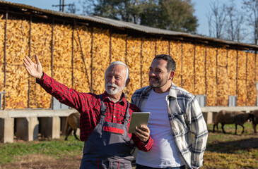 Happy ranchers using touchpad on a farm. © Budimir Jevtic