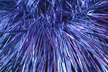 Christmas background, the texture of shiny tinsel. Toned in trendy Color Of The Year 2022 - Very Peri.