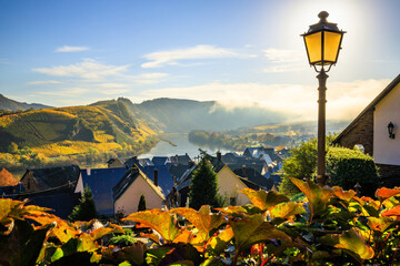 The Moselle loop, a beautiful river in Germany, makes a 180 degree loop. with vineyards and a great landscape and lighting in the morning. the church tower and the town of Bremm in autumn - obrazy, fototapety, plakaty
