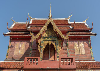 View of the upper floor of beautiful ancient teak wood ho trai or library at historic Wat Chai Sri Phum, Chiang Mai, Thailand