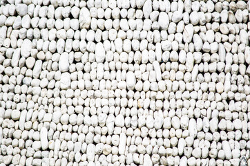 Round White Pebble rocks arrangement wall surface.