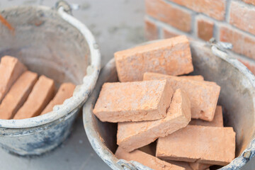 Close up bricks box in mortar bucket at a work site