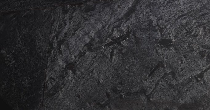 4K Video close up light and shadow on rock surface of modern architecture. Background for granite material and architecture detail.
