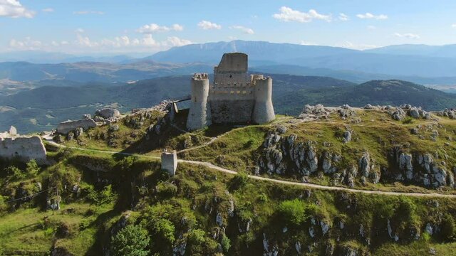 rocca calascio fortress aerial view drone flying up over abruzzi mountains landscape