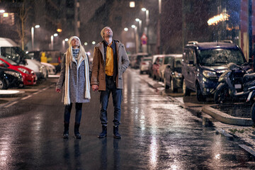 Happy  couple walking in a beautiful city in the night