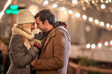 Joyful couple enjoying the winter night; Festive concept