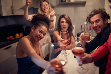 Multiethnic group of festive friends celebrating the New Year; Private party concept