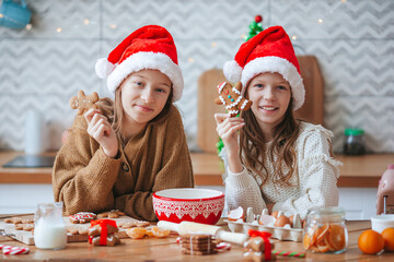 Little girls preparing Christmas gingerbread at home