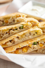 Closeup on sliced quesadilla with chicken and corn