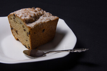 Cupcake with raisins on a white plate 